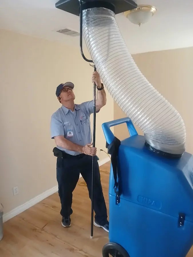 Furnace Tune-Up technician using HEPA equipment in Clermont