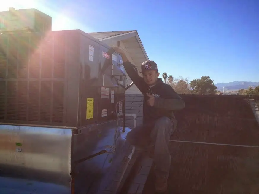 HVAC technician performing Heat Pump Repair on a rooftop unit in Clermont